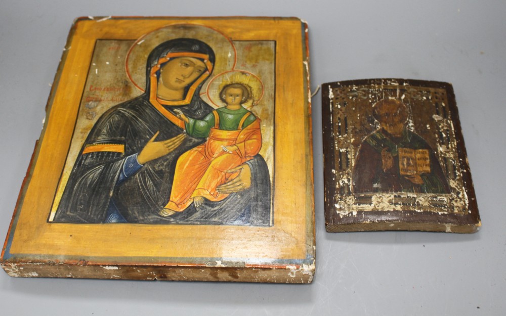 A 19th century Russian tempera on wood icon, 31 x 26cm and another smaller icon, 17.5 x 13cm